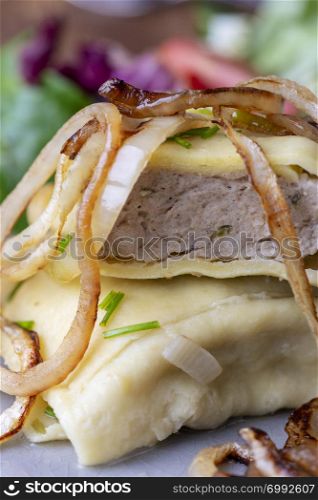 swabian maultasche with onions on a plate