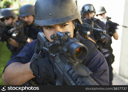 Swat officers aiming guns