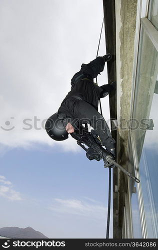 SWAT Team Officer Rappelling from Building