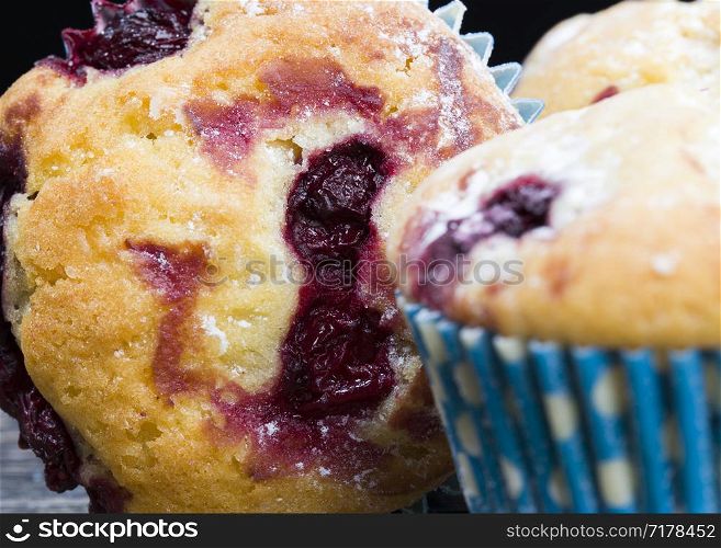 sweet and delicious cupcakes with whole ripe cherries inside, close-up of food and desserts, high-quality industrial baking. high-quality industrial baking