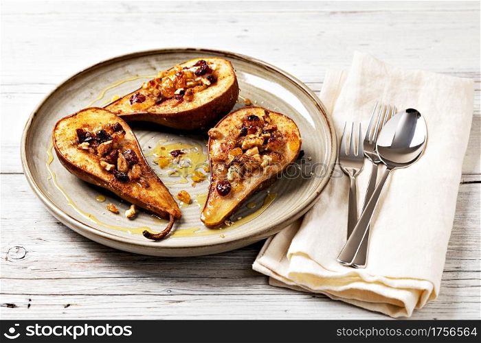 Sweet baked pears with honey, nuts, cranberries and cinnamon. Sweet baked pears with honey