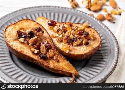 Sweet baked pears with honey, nuts, cranberries and cinnamon. Sweet baked pears with honey