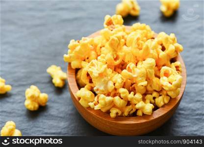 Sweet butter popcorn in bowl on dark plate backgroud