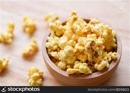 Sweet butter popcorn in bowl on wooden backgroud