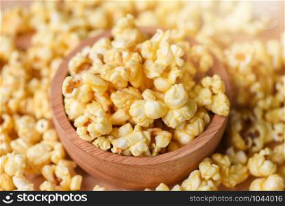 Sweet butter popcorn salt in wooden cup bowl and popcorn backgroubd top view