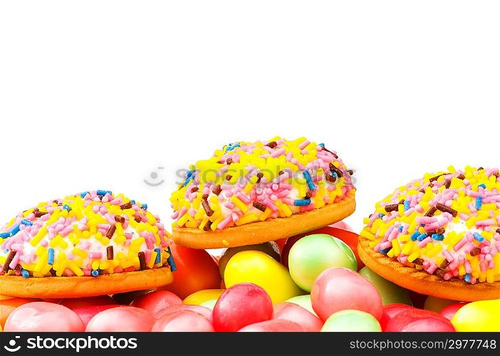 Sweet cakes and colourful gums at the background
