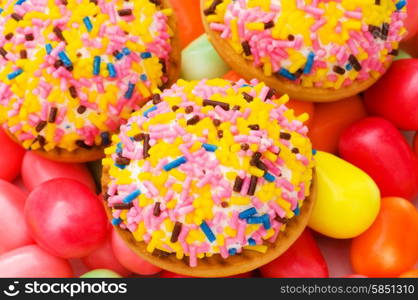 Sweet cakes and colourful gums at the background