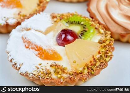 sweet cakes with fruits closeup photo. sweet cakes