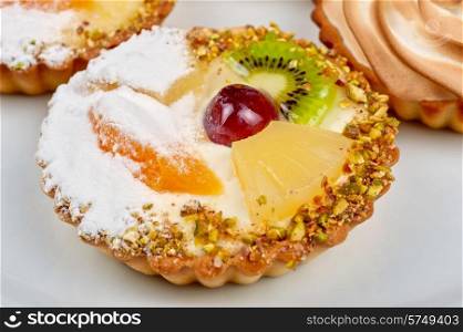 sweet cakes with fruits closeup photo. sweet cakes