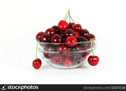 Sweet cherries in a glass bowl isolated on white