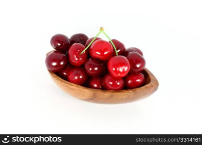 Sweet cherries in a wood bowl, isolated on white