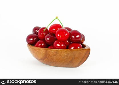 Sweet cherries in wooden bowl isolated on white