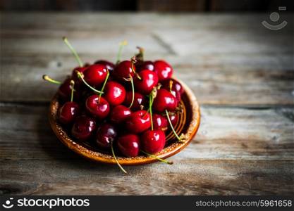 Sweet cherries on rustic wooden background