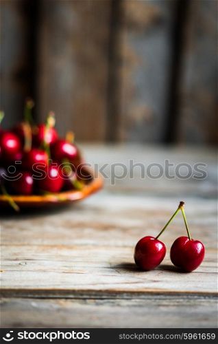 Sweet cherries on rustic wooden background