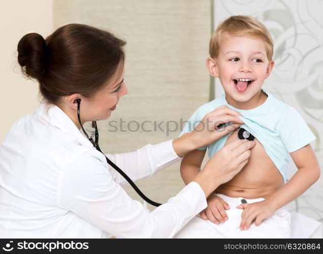 Sweet child visiting doctor, beautiful young specialist examines the health of a small patient, treatment in the good clinic, happy healthy childhood
