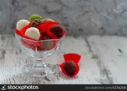 Sweet chocolate truffles on the white background