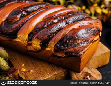 Sweet cinnamon bun on wooden board