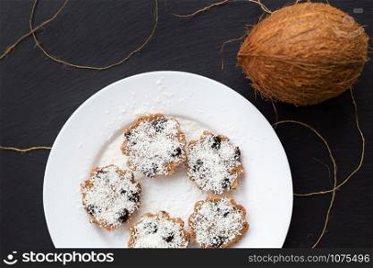 sweet coconut muffins on a white plate on a black board. sweet coconut muffins on a white plate on a black board.
