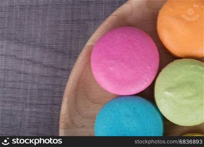 sweet colorful cake macaron or macaroon in plate on wood table
