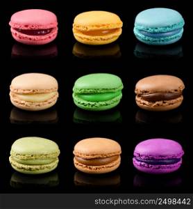Sweet colorful macarons isolated on black background. French macaroons set.