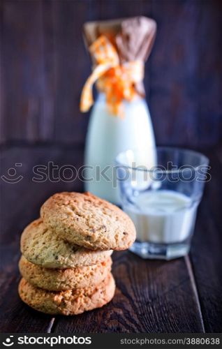 sweet cookies and milk in glass on a table