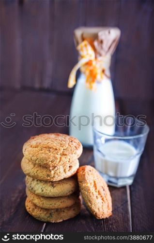 sweet cookies and milk in glass on a table