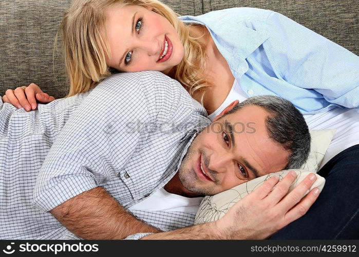 sweet couple embracing on the couch