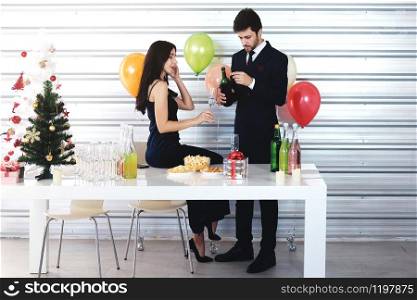 Sweet couple Love smile and spending Romantic with drinking wine in christmas time and celebrating new year eve, valentine day with colorful balloon and Gift Boxes at pantry area