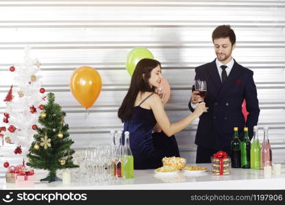 Sweet couple Love smile and spending Romantic with drinking wine in christmas time and celebrating new year eve, valentine day with colorful balloon and Gift Boxes at pantry area