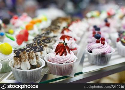 Sweet cream cupcakes on bakery display. Selective focus.