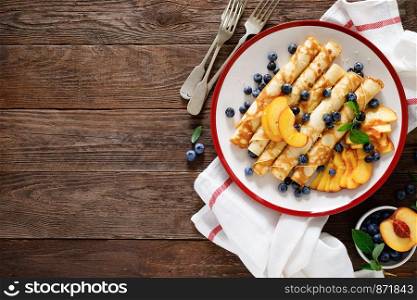 Sweet crepes filled with fresh blueberry and peach