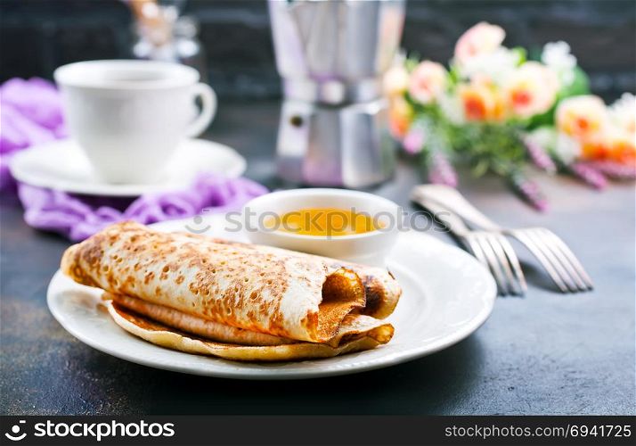 sweet crepes with honey,pancakes on the plate
