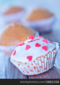 sweet cupcakes on a table, muffins on wooden table