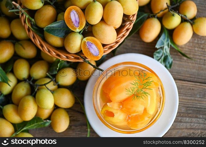 Sweet dessert marian plum fruit  on bowl for food and wooden background, tropical fruit Name in Thailand sweet Yellow Marian Plum Maprang Plango or Mayong chid