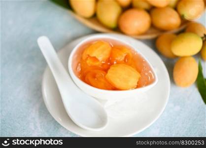 Sweet dessert marian plum fruit  on bowl for food and wooden background, tropical fruit Name in Thailand sweet Yellow Marian Plum Maprang Plango or Mayong chid