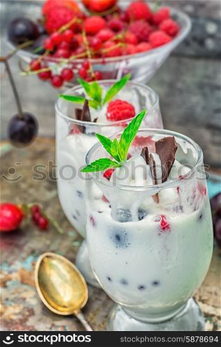 sweet dessert of ice cream per glass and fresh berries, cherries,currants,strawberries.