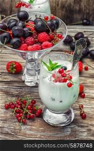 sweet dessert of ice cream per glass and fresh berries, cherries,currants,strawberries.