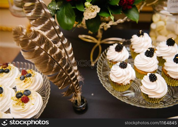 Sweet dessert table at a wedding.Cakestand at a wedding day. Sweet dessert table at a wedding.Cakestand at a wedding