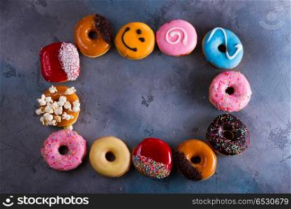 sweet doughnuts on gray stone background. sweet doughnuts on gray background, frame with copy space