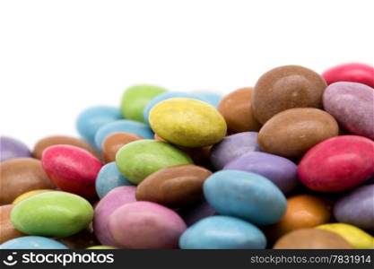 sweet dragees of different color on white background