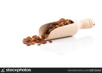 Sweet dry raisins in scoop isolated on the white background