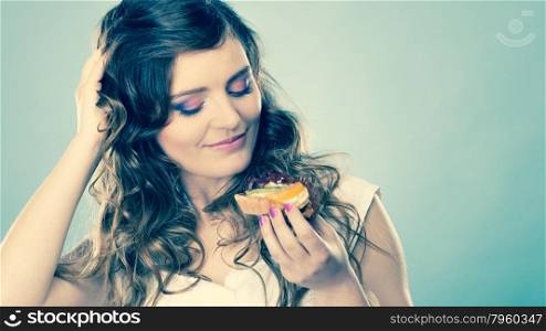 Sweet food sugar make us happy. Cute young woman colorful makeup nails holds fruit cake in hand instagram photo