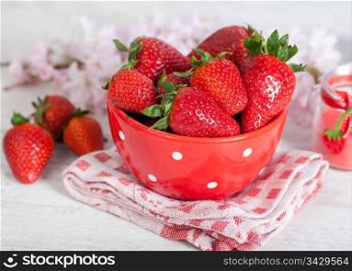 Sweet fresh strawberries in a red bowl
