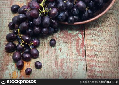 sweet grapes in basket wooden background