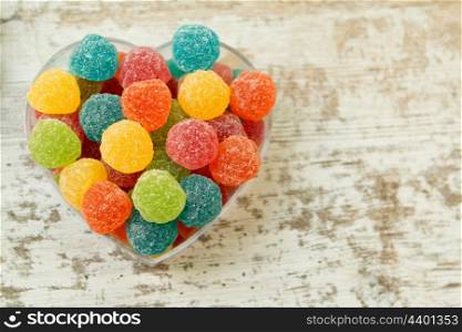 Sweet heart with jellybeans on a wooden background