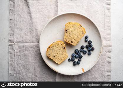 Sweet homemade pastries cutting muffin with blueberries and fresh berries on white background, top view.. homemade muffin with blueberries