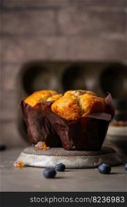 Sweet homemade pastries muffin with blueberries and fresh berries on stone background.. homemade muffin with blueberries