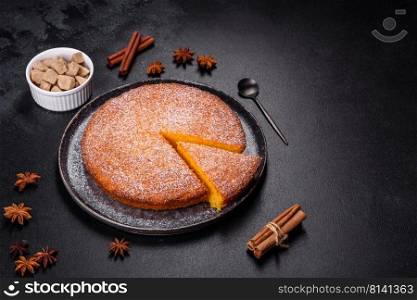 Sweet Homemade Thanksgiving Pumpkin Pie Ready to Eat. Pumpkin pie on marble cutting board. Dark background. Copy space