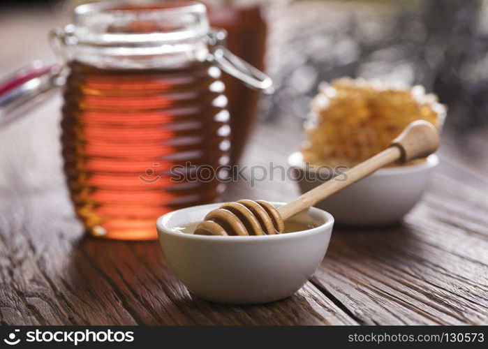 Sweet honey in the comb. Jar of honey with honeycomb