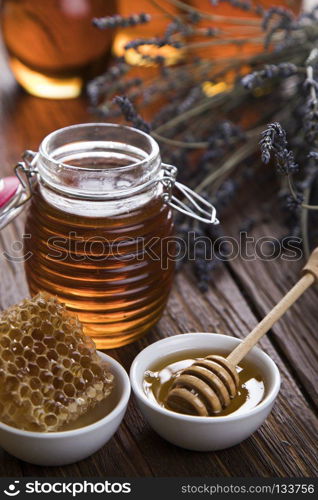 Sweet honey in the comb. Jar of honey with honeycomb